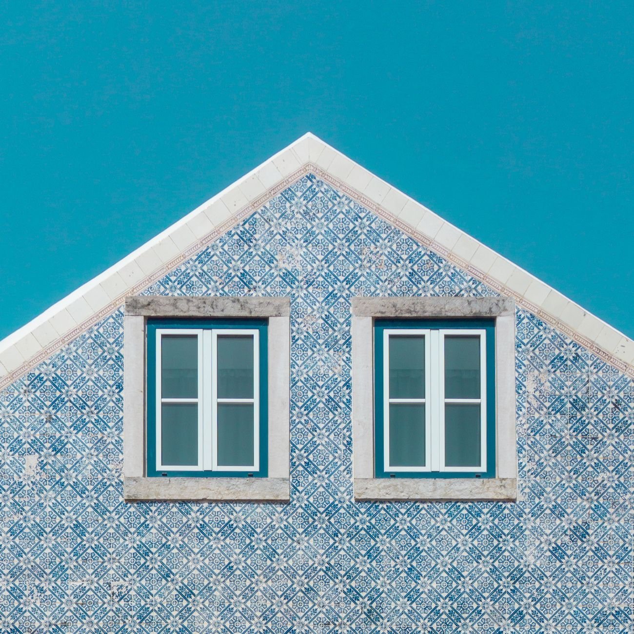 Close-up of a Portuguese house with azulejo tiles — the distinctive blue and terracotta patterns of Lisbon.