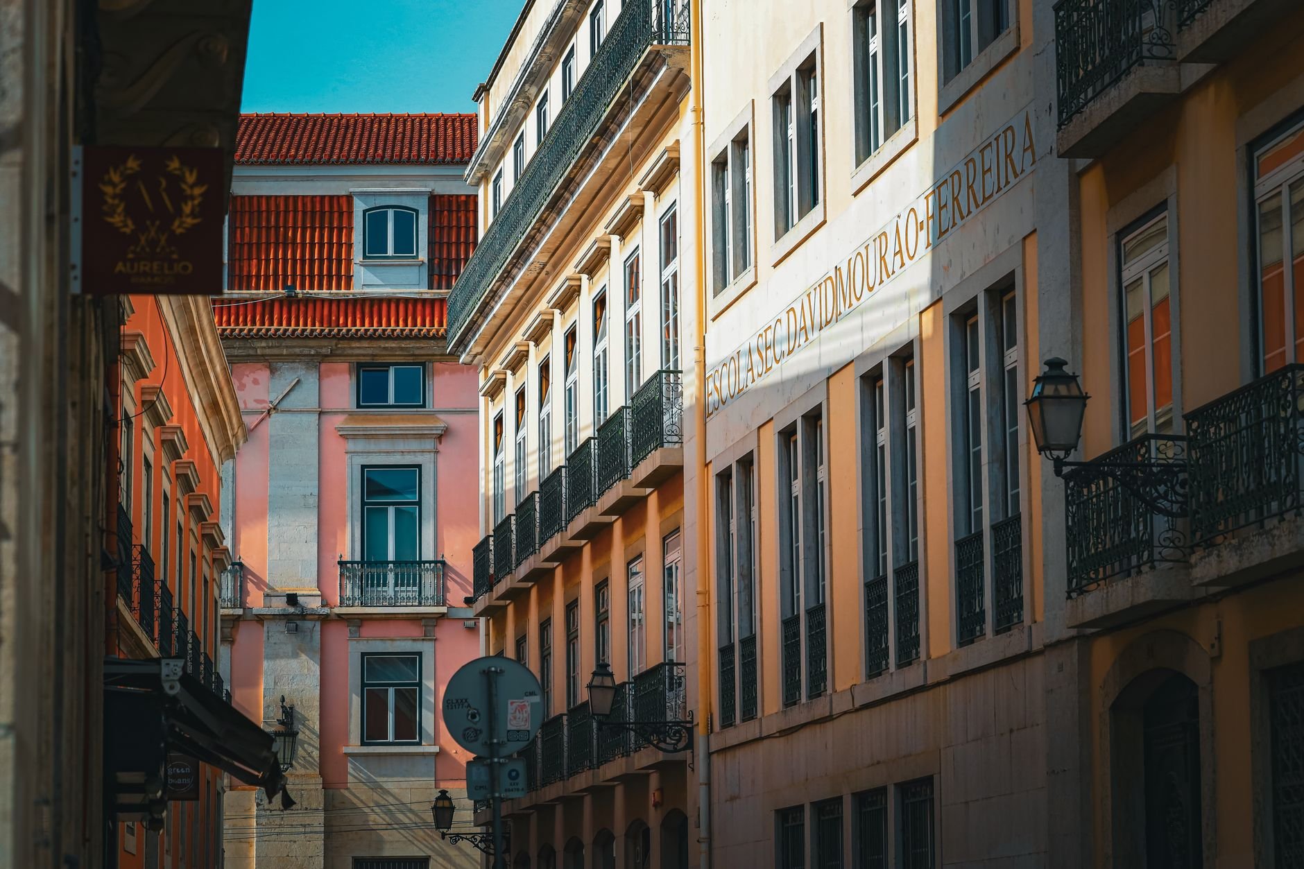 Charming street view of colourful buildings in Lisbon's architectural district under bright daylight.